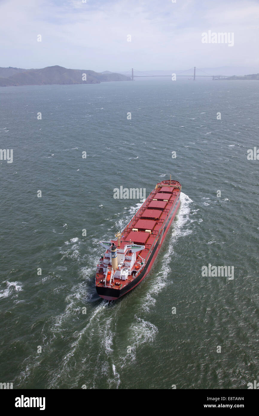 Aerial view of container ship in urban harbor, San Francisco, California, United States Stock Photo