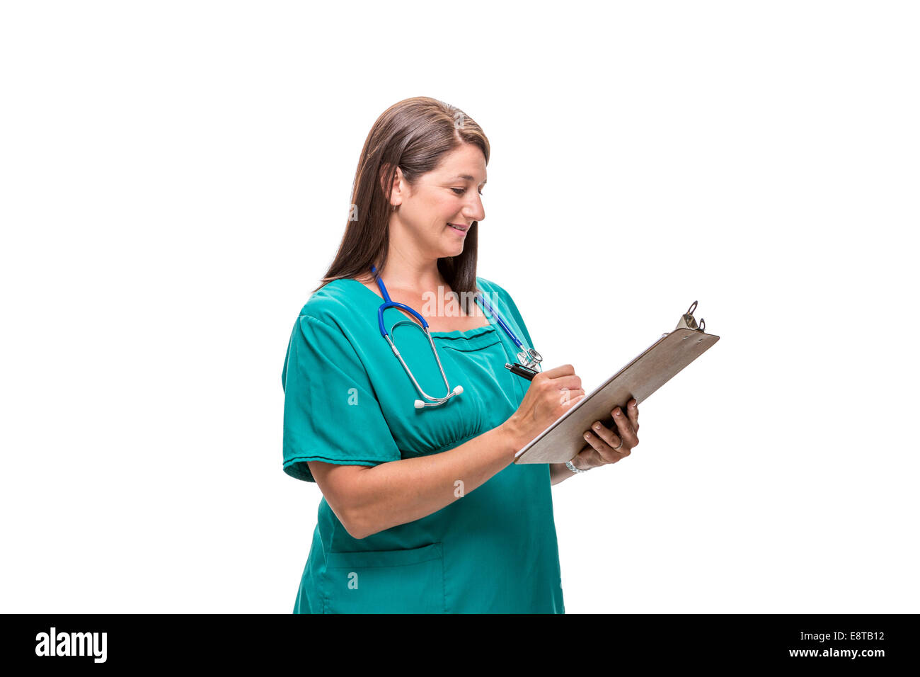 Caucasian nurse writing on clipboard Stock Photo