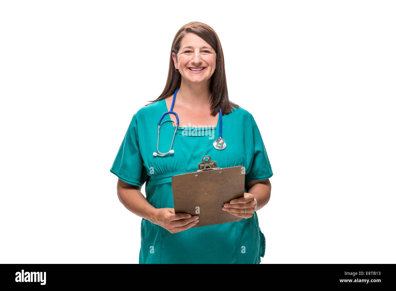 Caucasian nurse holding clipboard Stock Photo