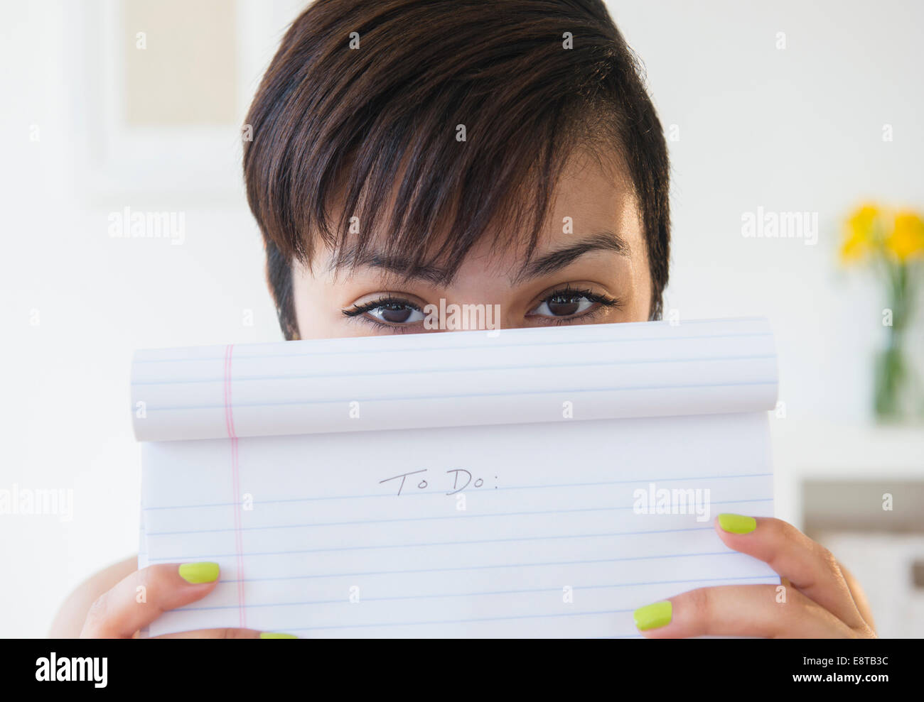Mixed race woman holding empty to do list Stock Photo