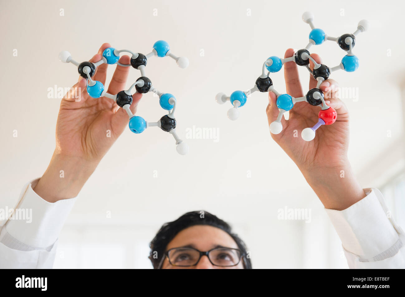 Close up of mixed race scientist holding molecular models Stock Photo