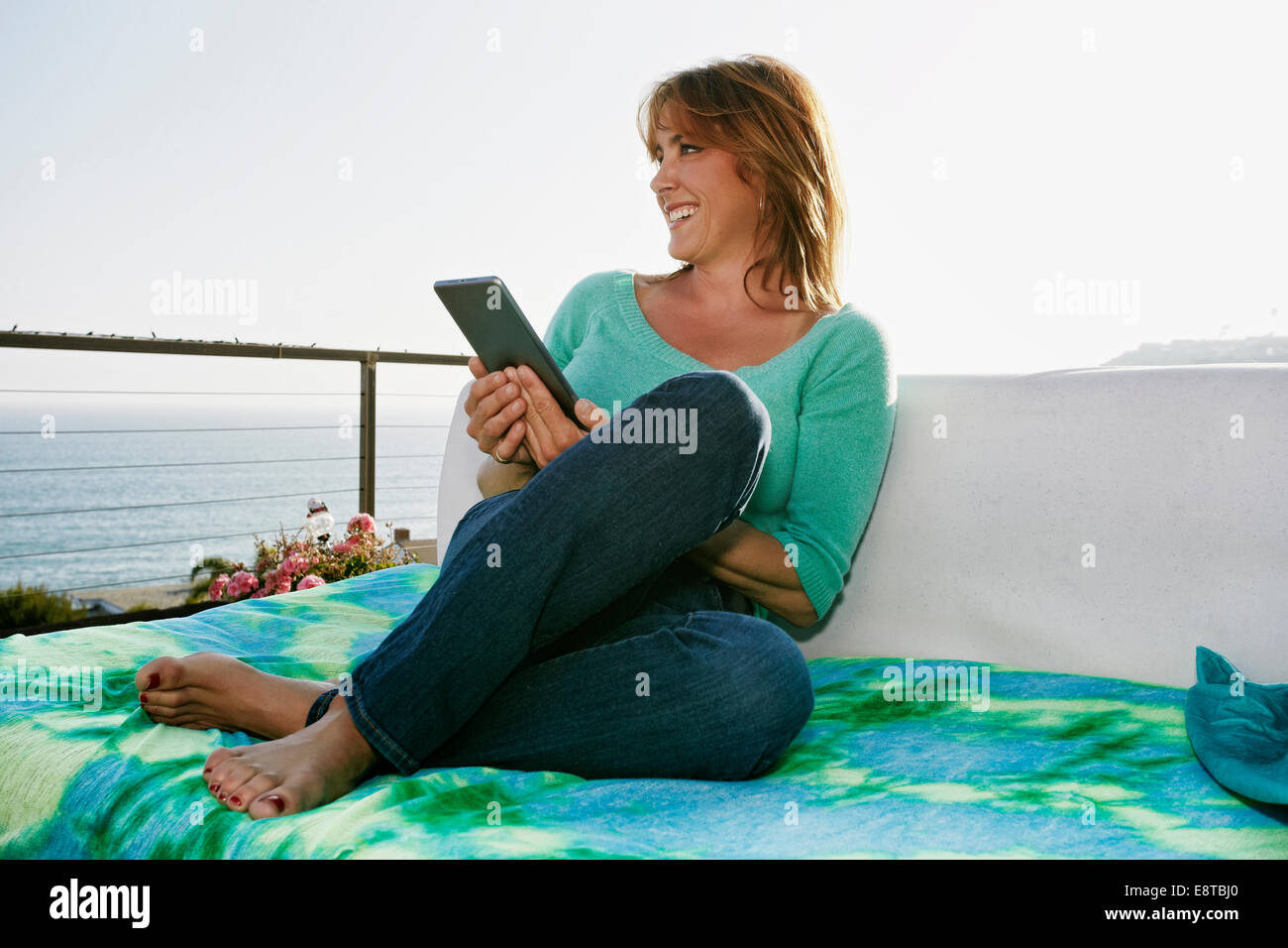 Caucasian woman using digital tablet at waterfront Stock Photo