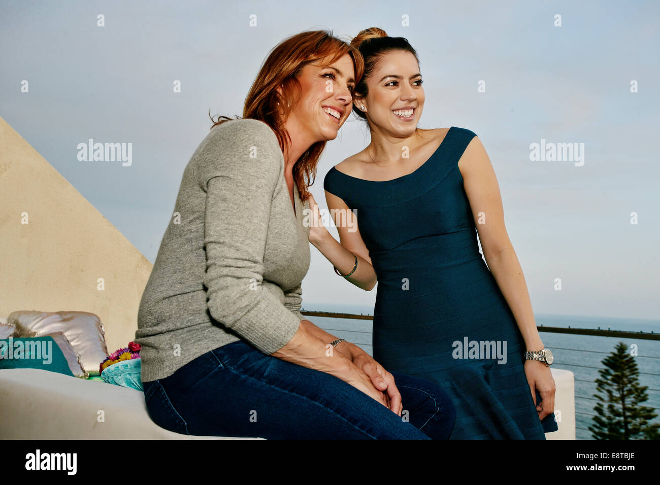 Women relaxing together at waterfront Stock Photo
