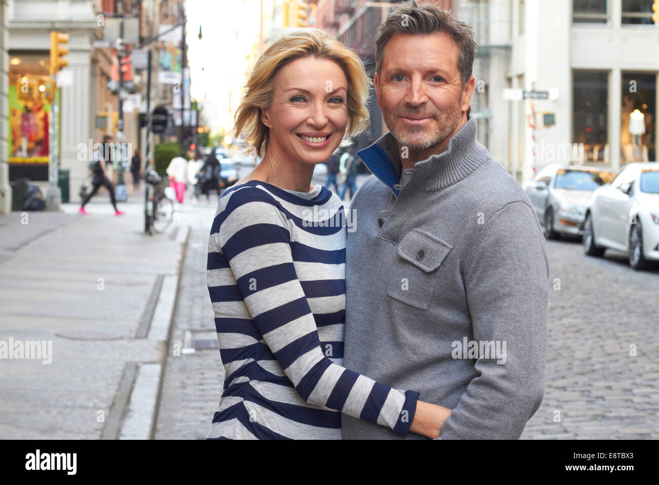 Caucasian couple hugging on city street, New York City, New York, United States Stock Photo