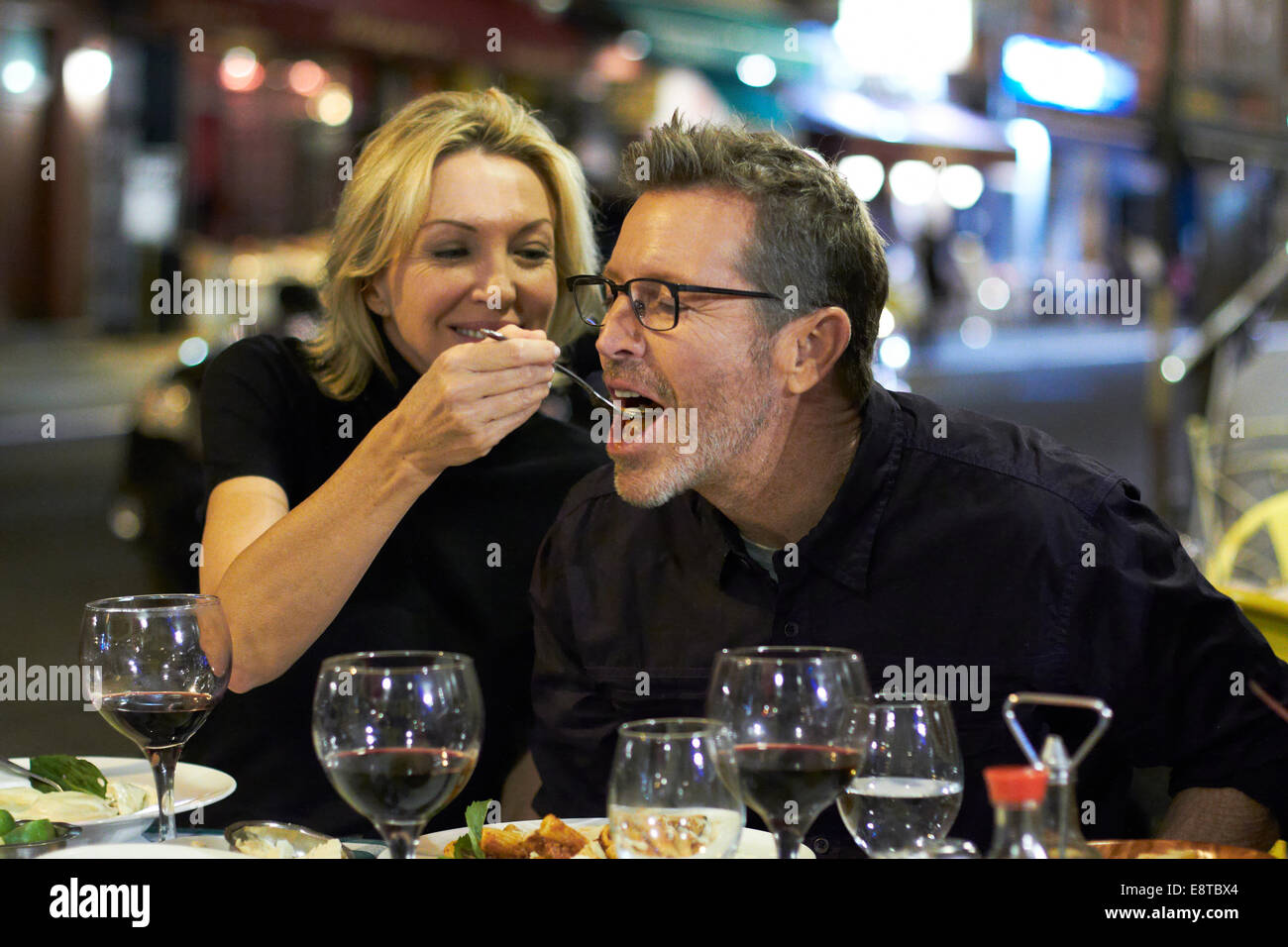 Caucasian couple eating at urban cafe, New York City, New York, United States Stock Photo