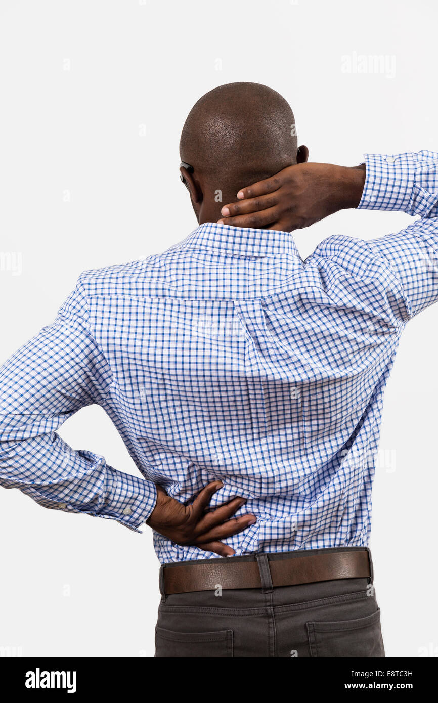 Black man rubbing aching back and neck Stock Photo