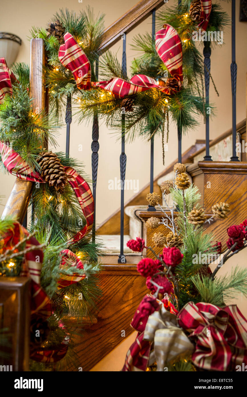 Banister decorated with boughs and string lights for Christmas Stock