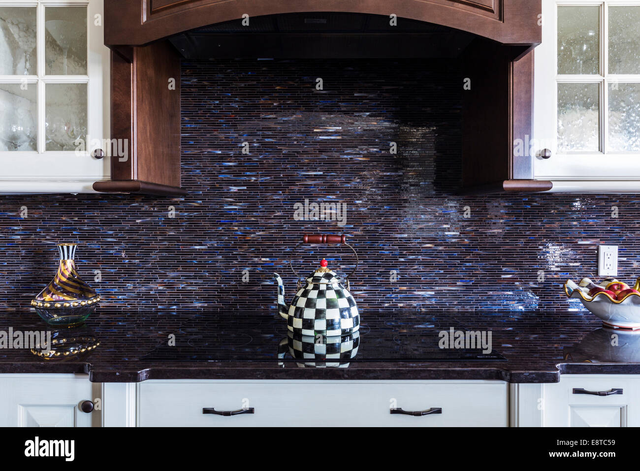 Checkered teapot on stove in kitchen Stock Photo Alamy