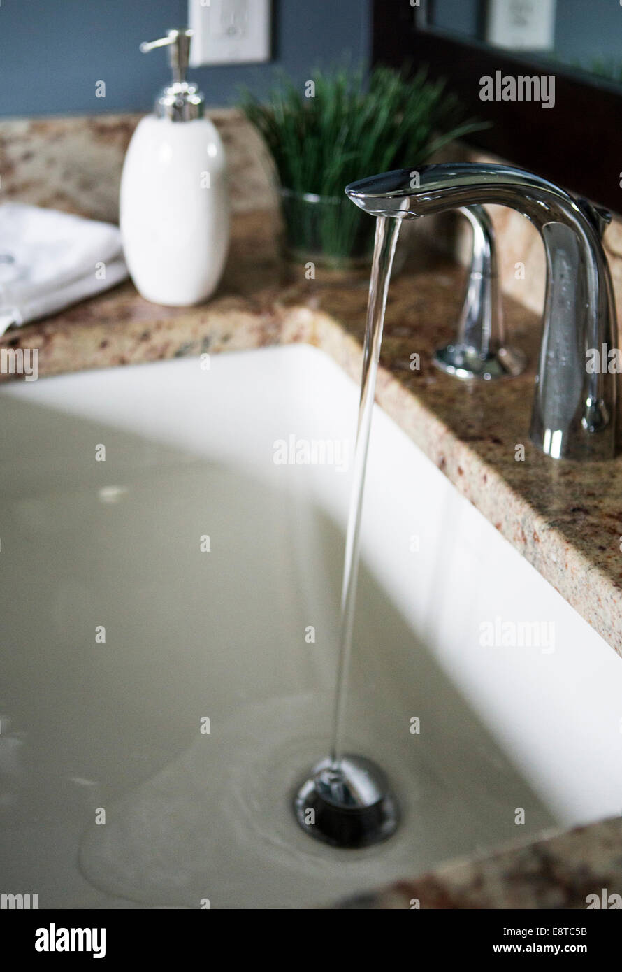 Water flowing from faucet in modern bathroom sink Stock Photo Alamy