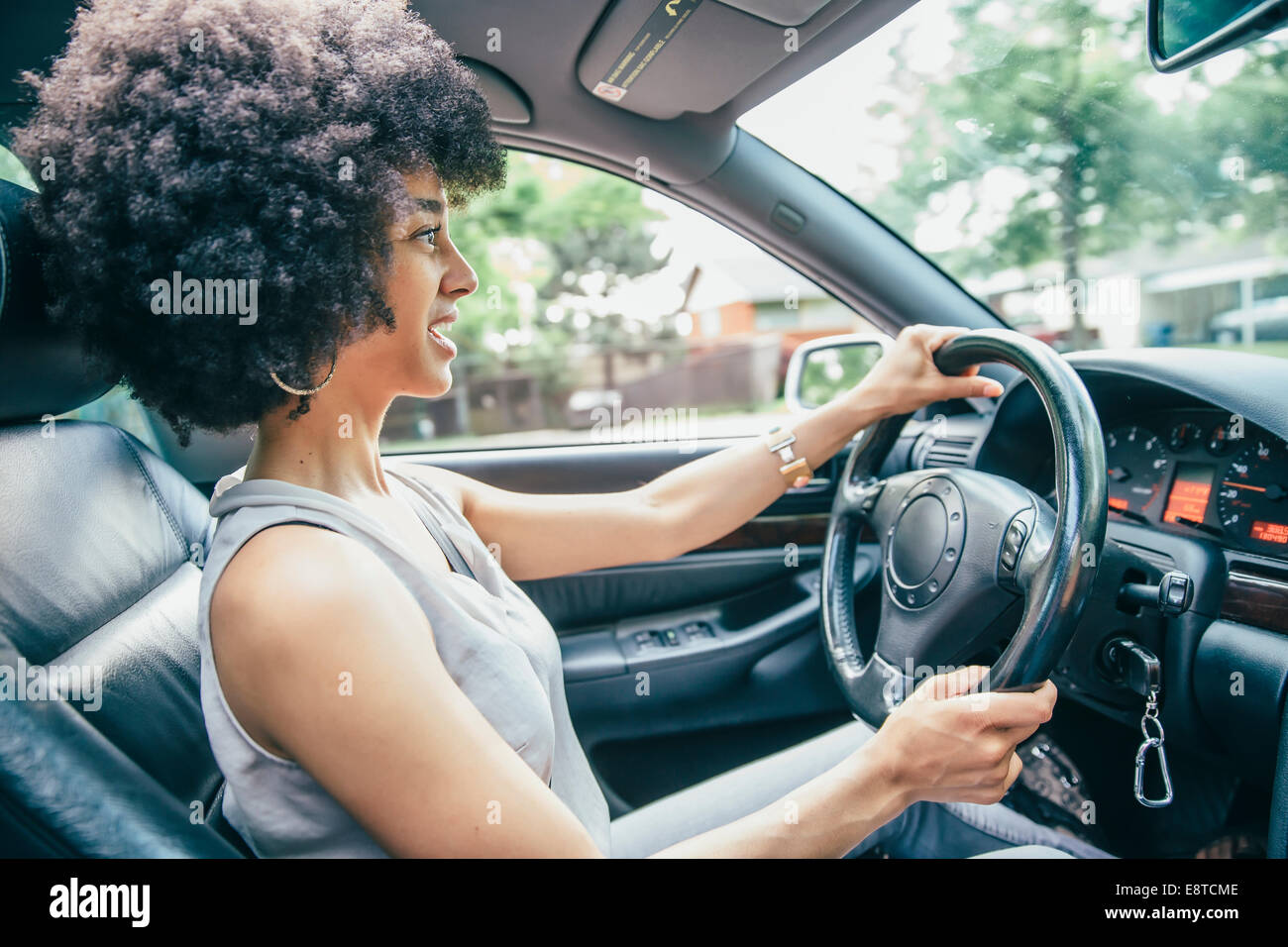 Mixed race woman driving car Stock Photo