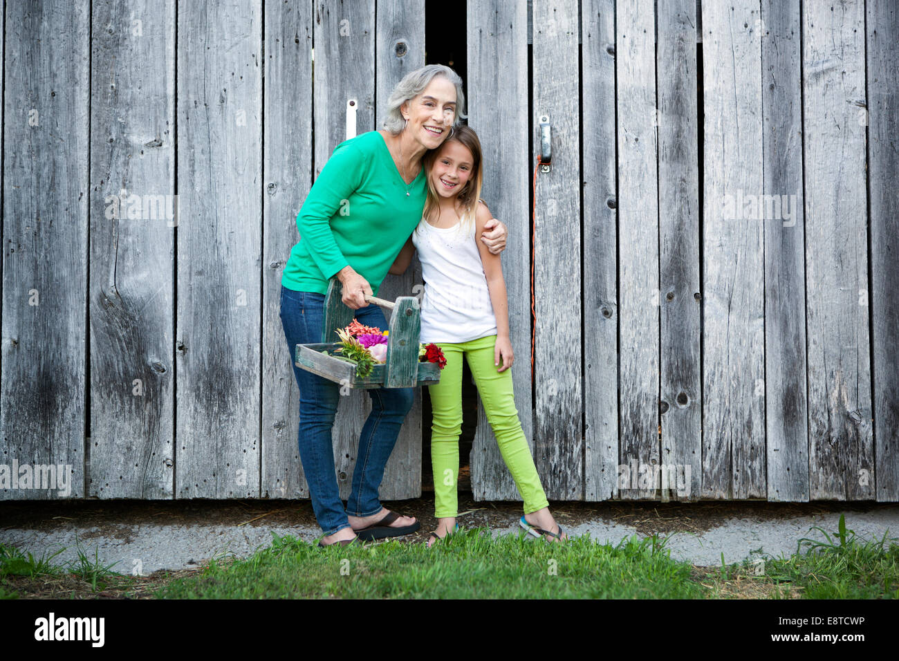 Caucasian grandmother and granddaughter smiling on farm Stock Photo