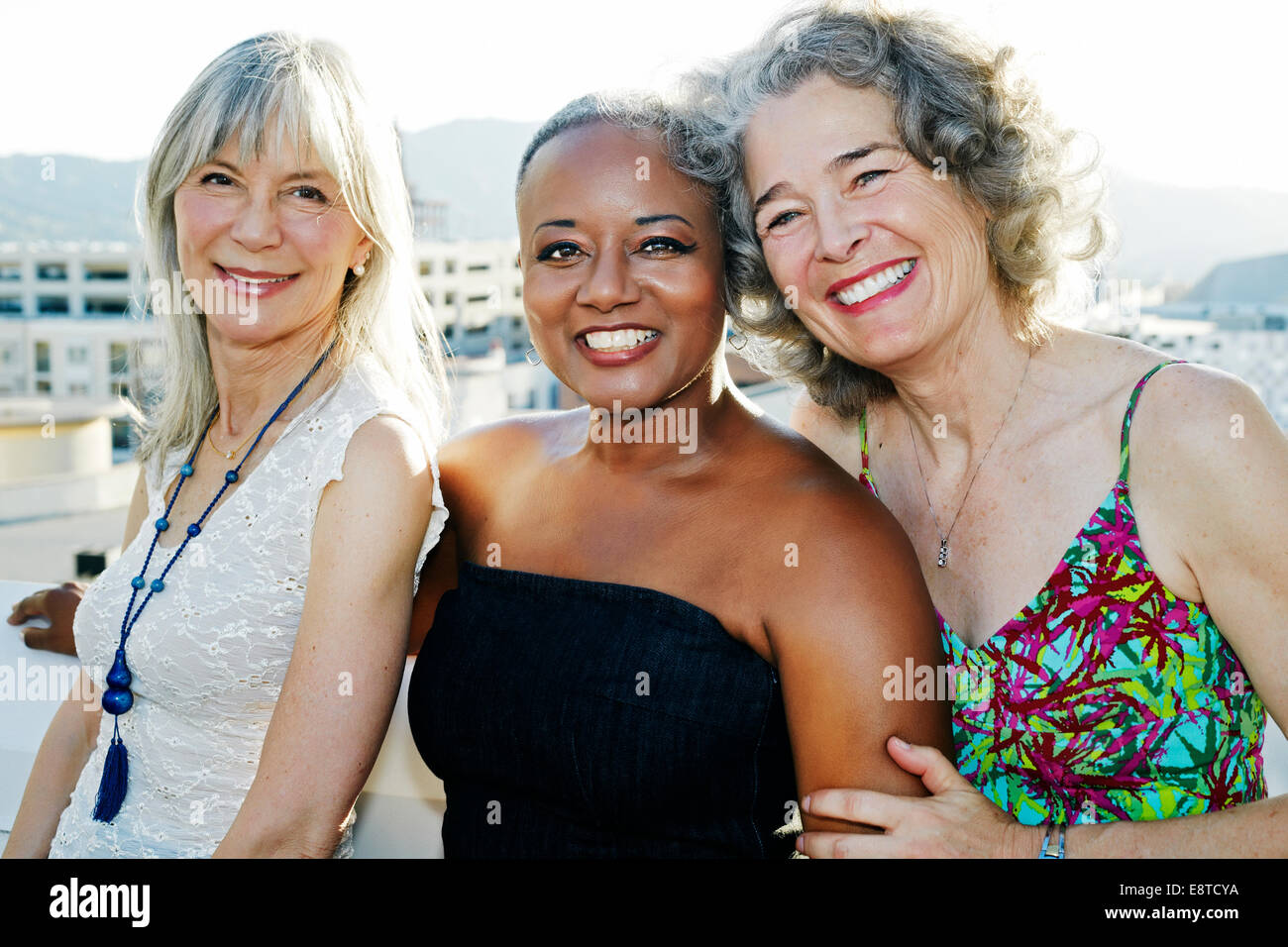 Women smiling together on urban rooftop Stock Photo - Alamy