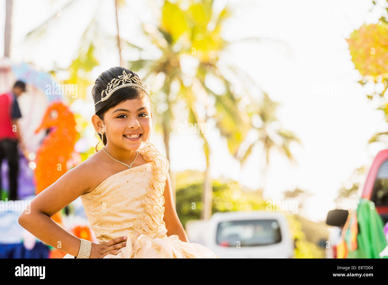 Hispanic girl posing in ornate dress and tiara Stock Photo