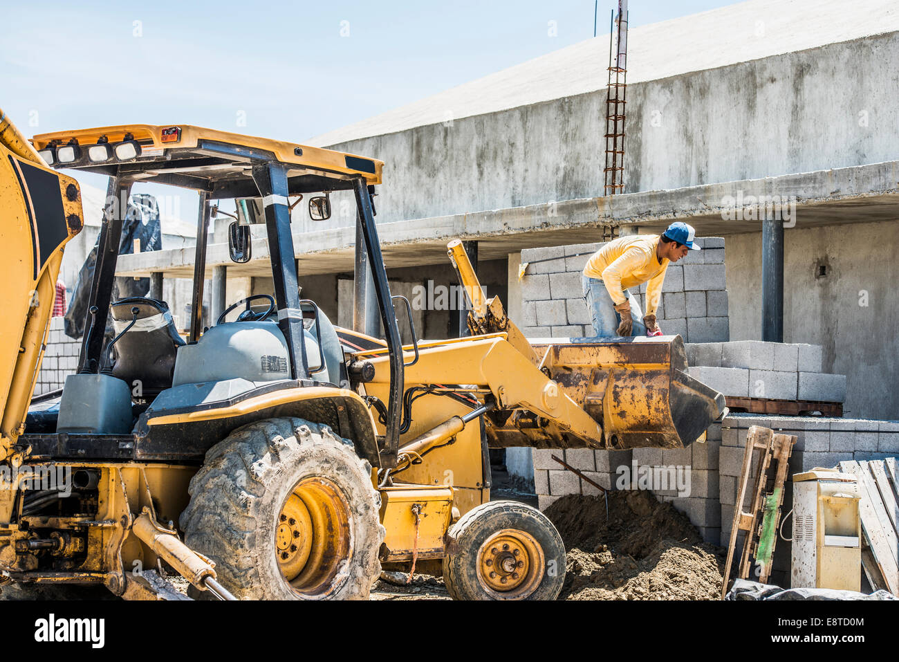 Hispanic construction worker on bulldozer at construction site Stock Photo