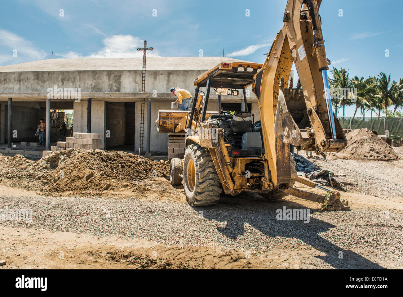 Hispanic construction worker on bulldozer at construction site Stock Photo