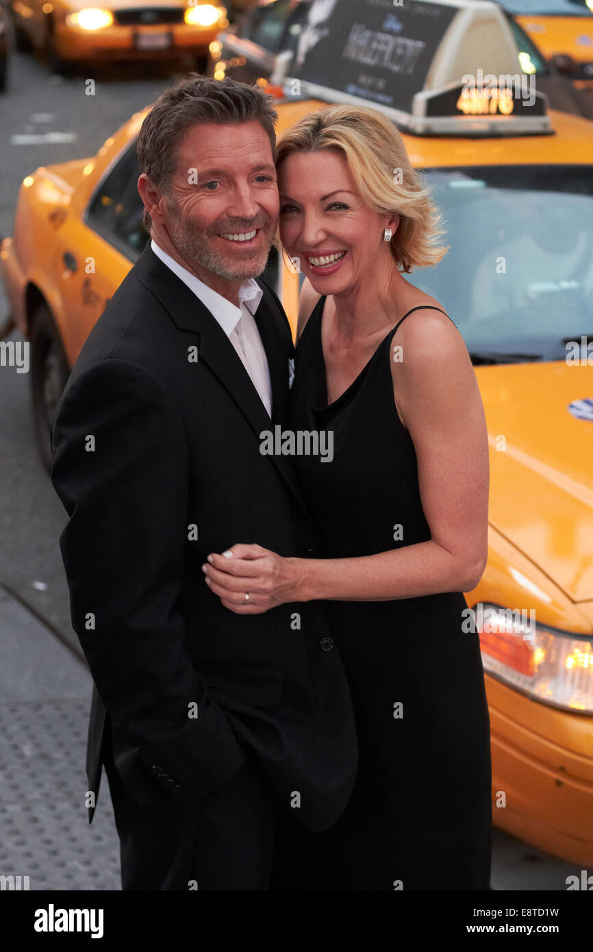 Caucasian couple hugging near taxi, New York City, New York, United States Stock Photo