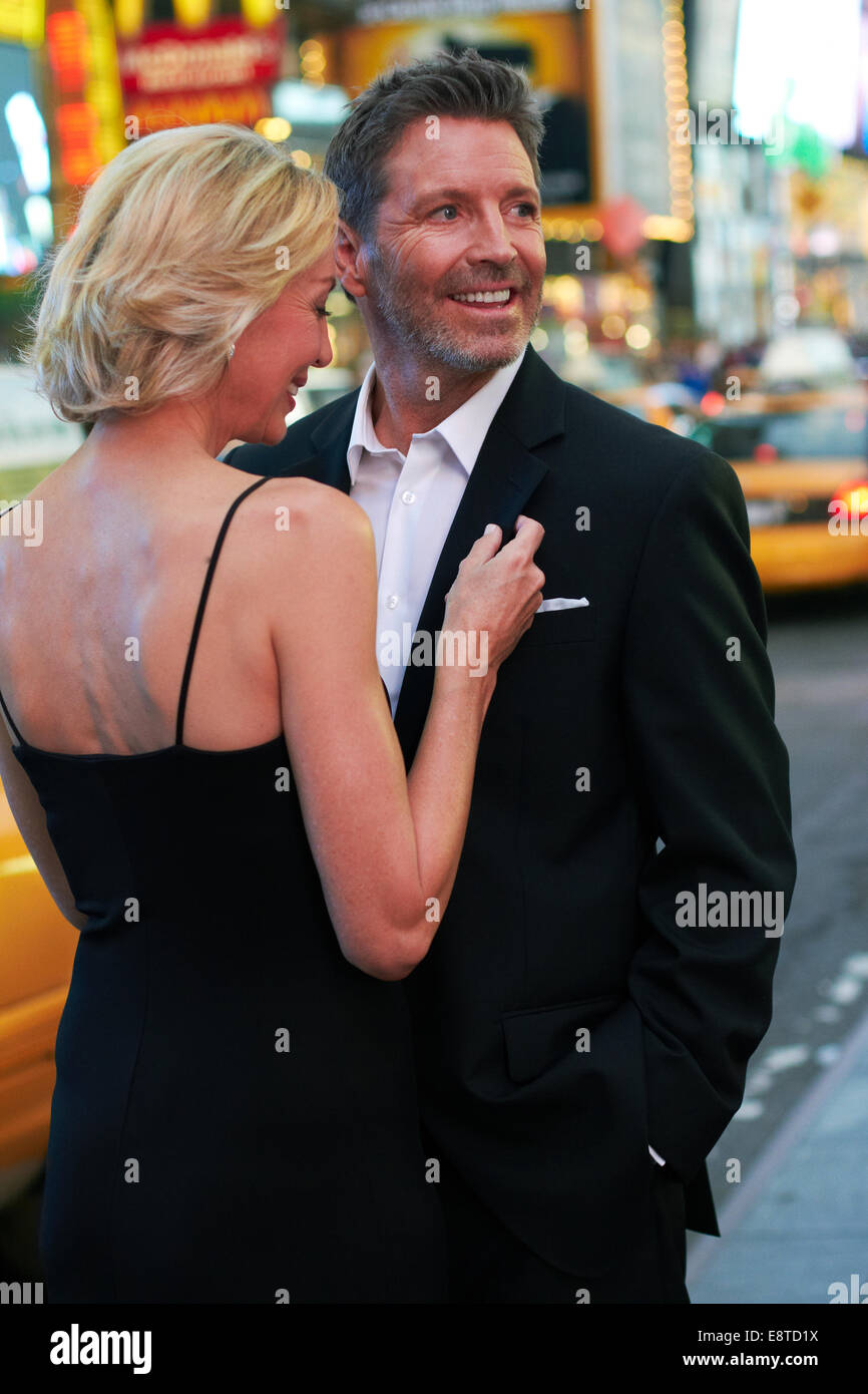 Caucasian couple hugging in Times Square, New York City, New York, United States Stock Photo