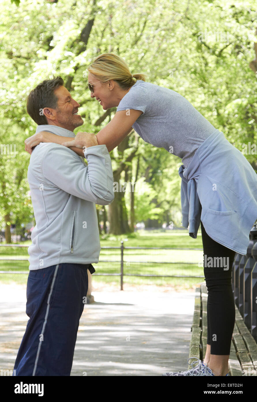 Caucasian couple playing in park Stock Photo