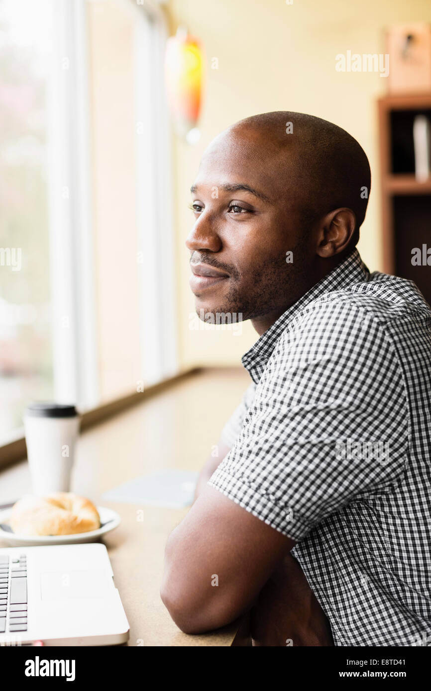 Black man relaxing in coffee shop Stock Photo