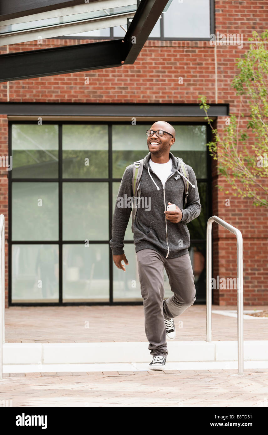Black man walking in city Stock Photo