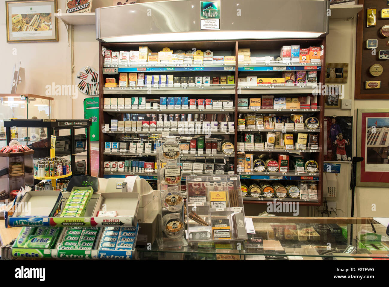 Inside displays of a tobacconist shop that sells cigarettes, lose tobacco, pipe tobacco and