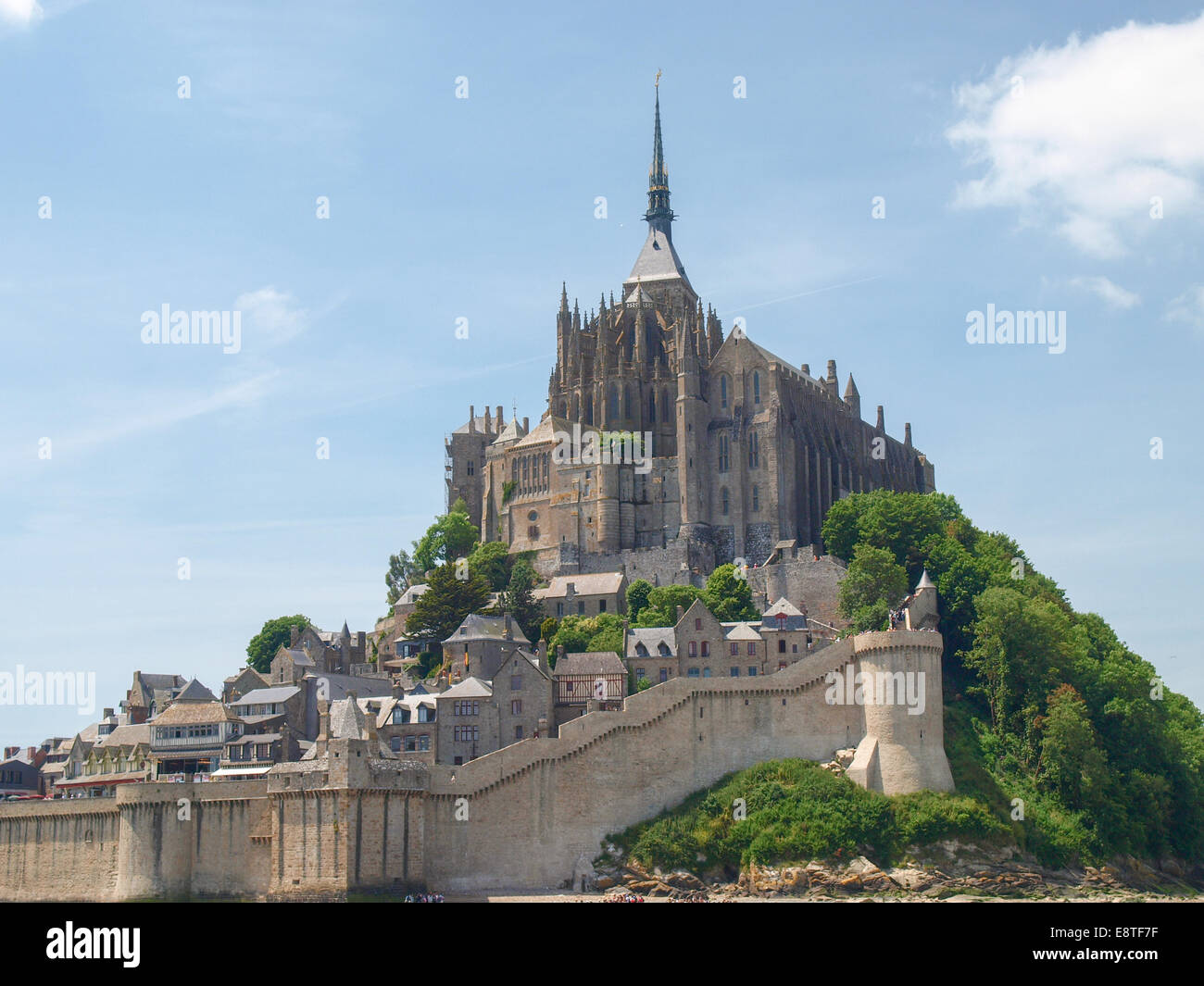 Mont St. Michel, France June 13, 2014: Abbey of Mont St. Michel. View of the Abbey from the sands at low tide. There are some un Stock Photo