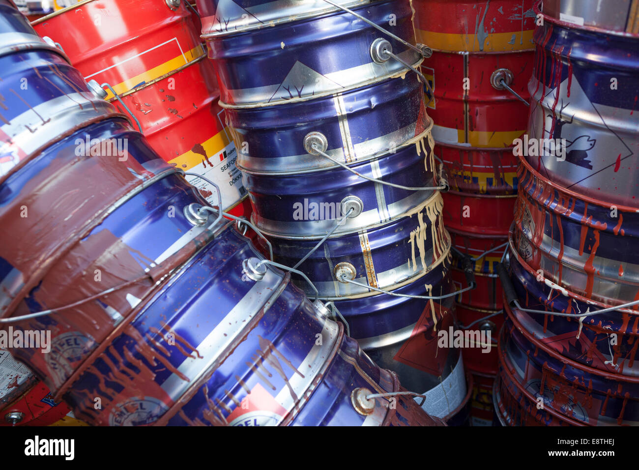 Empty paint cans stacked in skip Stock Photo Alamy