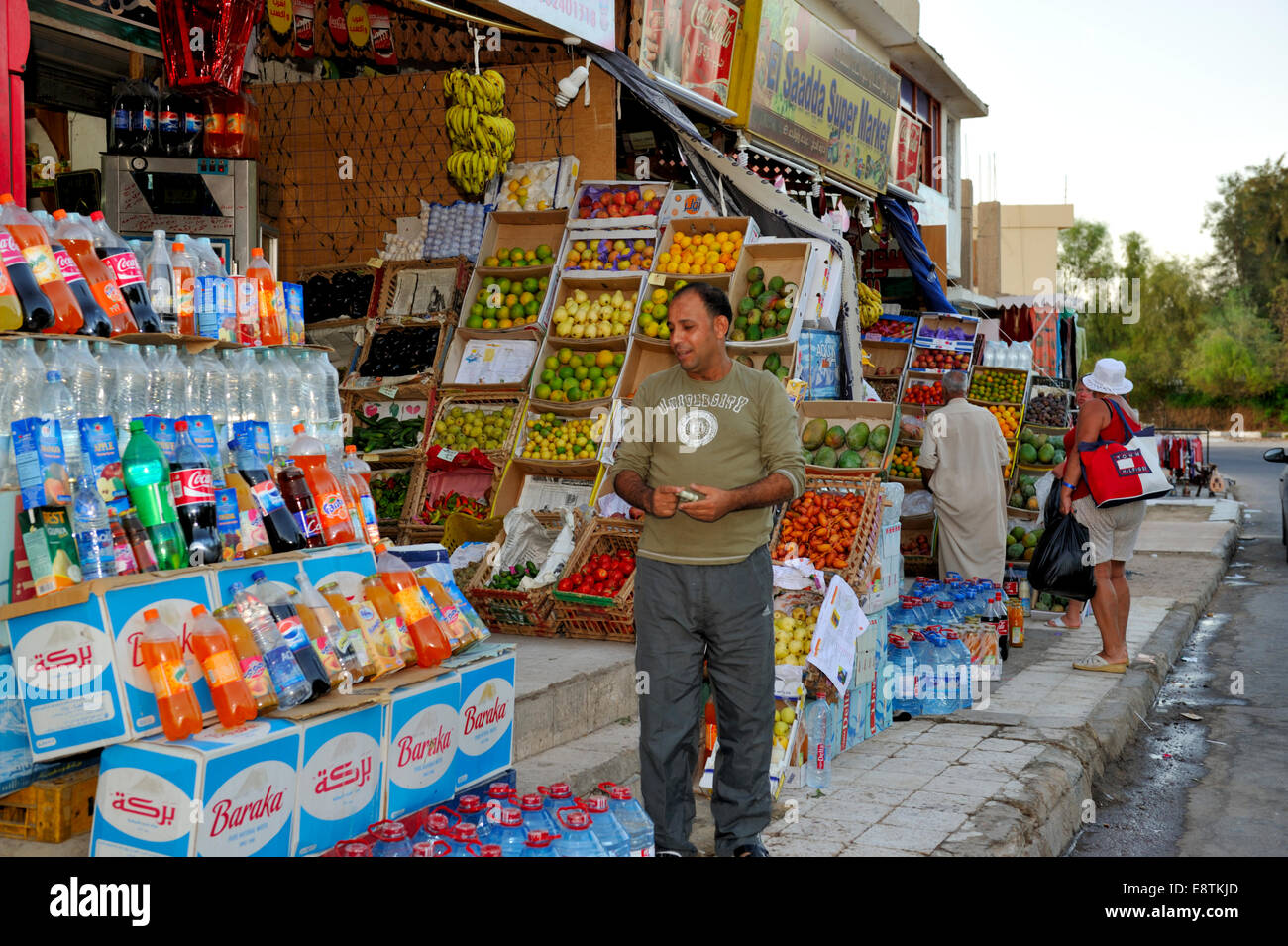 Egyptian shop keepers standing, sitting outside their small shops