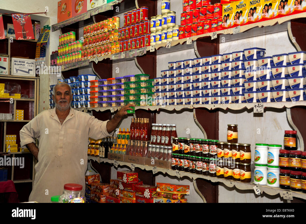 Egyptian shop keeper standing inside his small food shop, Nuweiba