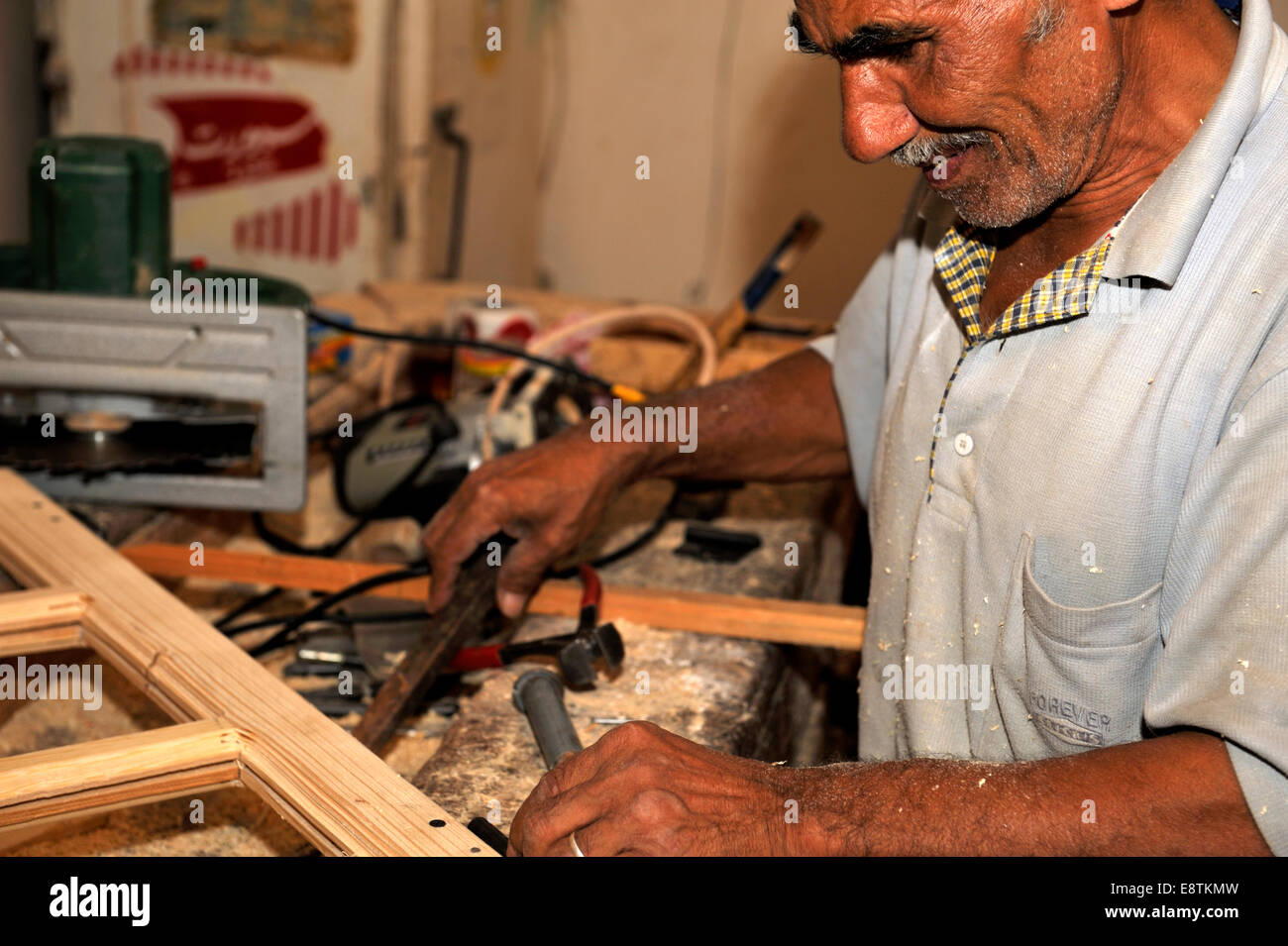 Egyptian carpenter hand making a window Stock Photo