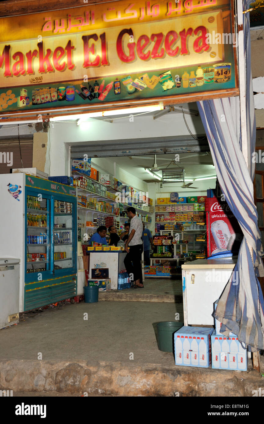 Inside a small Egyptian food store with customer at counter Stock Photo