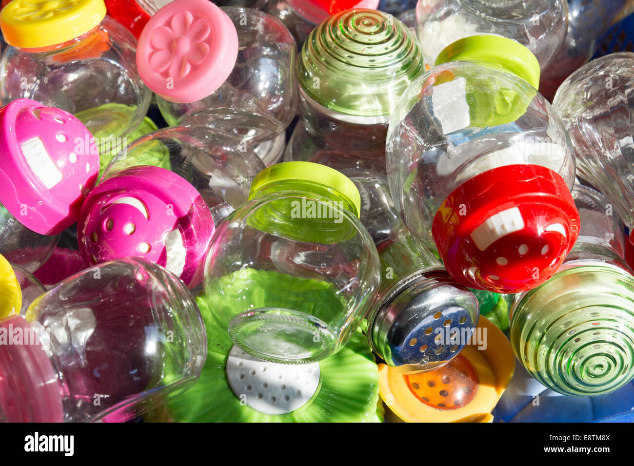 A selection of glass jars with a variety of brightly coloured colored lids for sale at the Souk El Had, Agadir, Morocco. Stock Photo