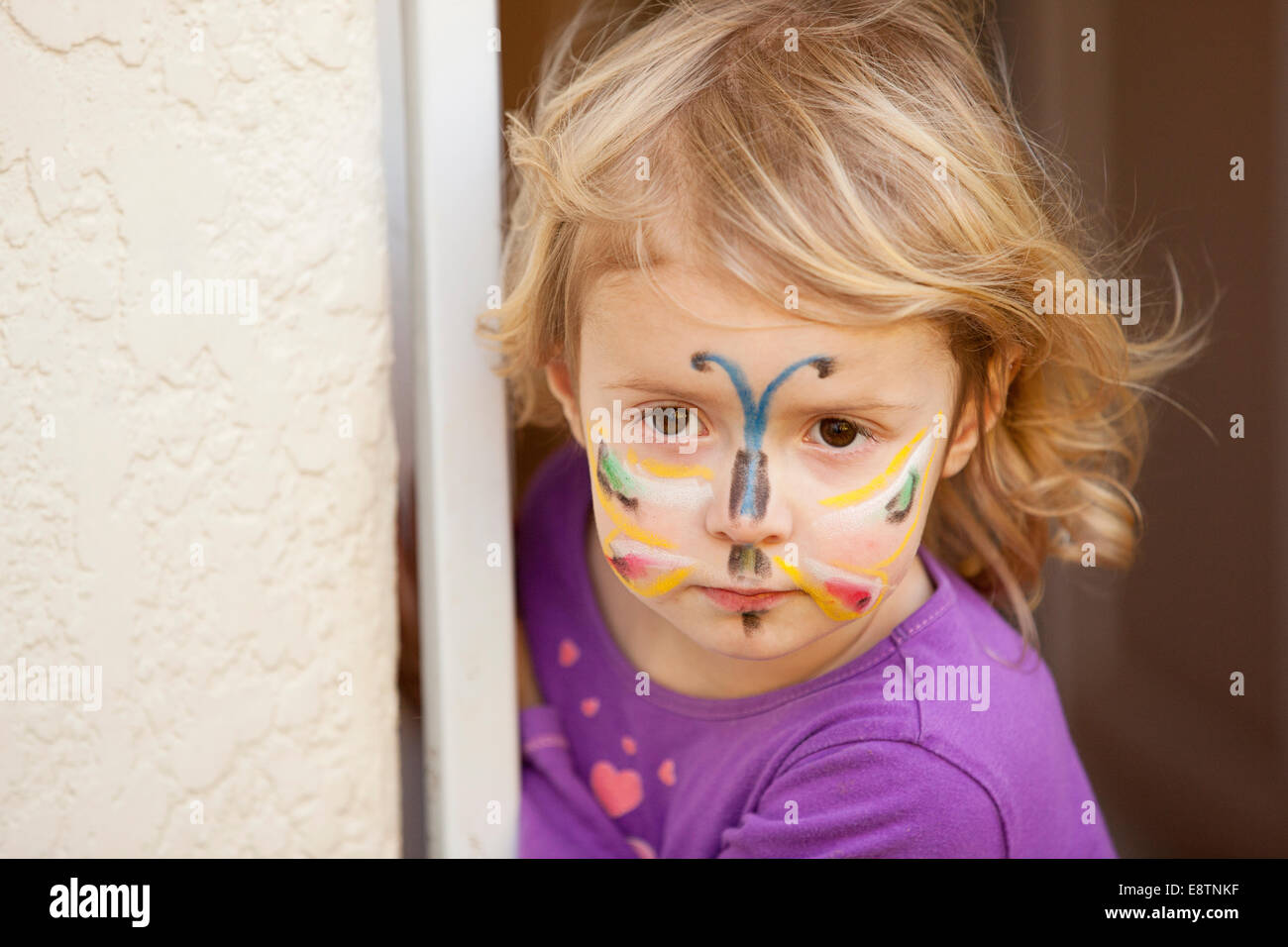 Girl with butterfly face paint. Stock Photo