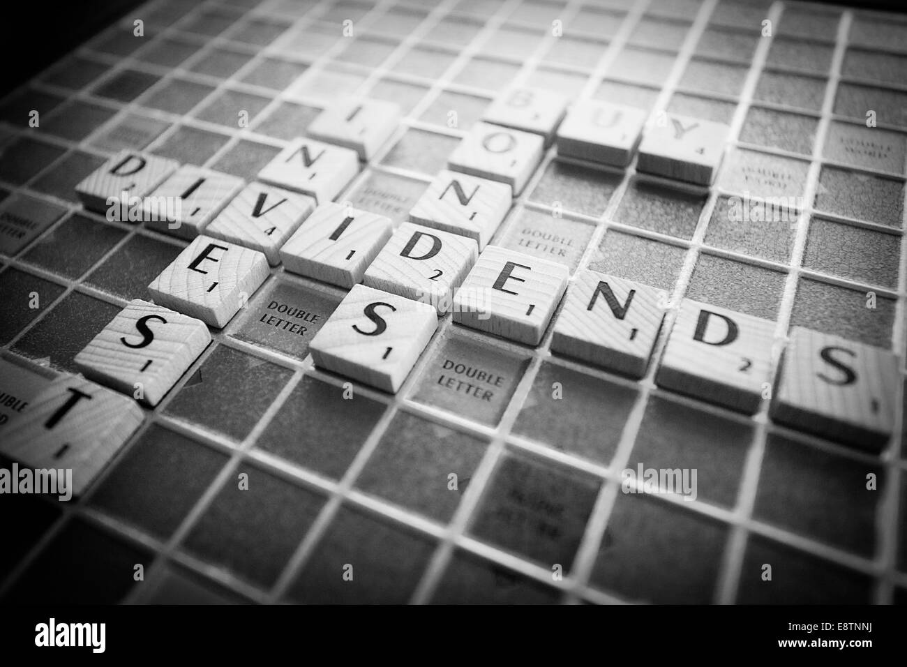 Financial terms spelled out on a Scrabble board Stock Photo