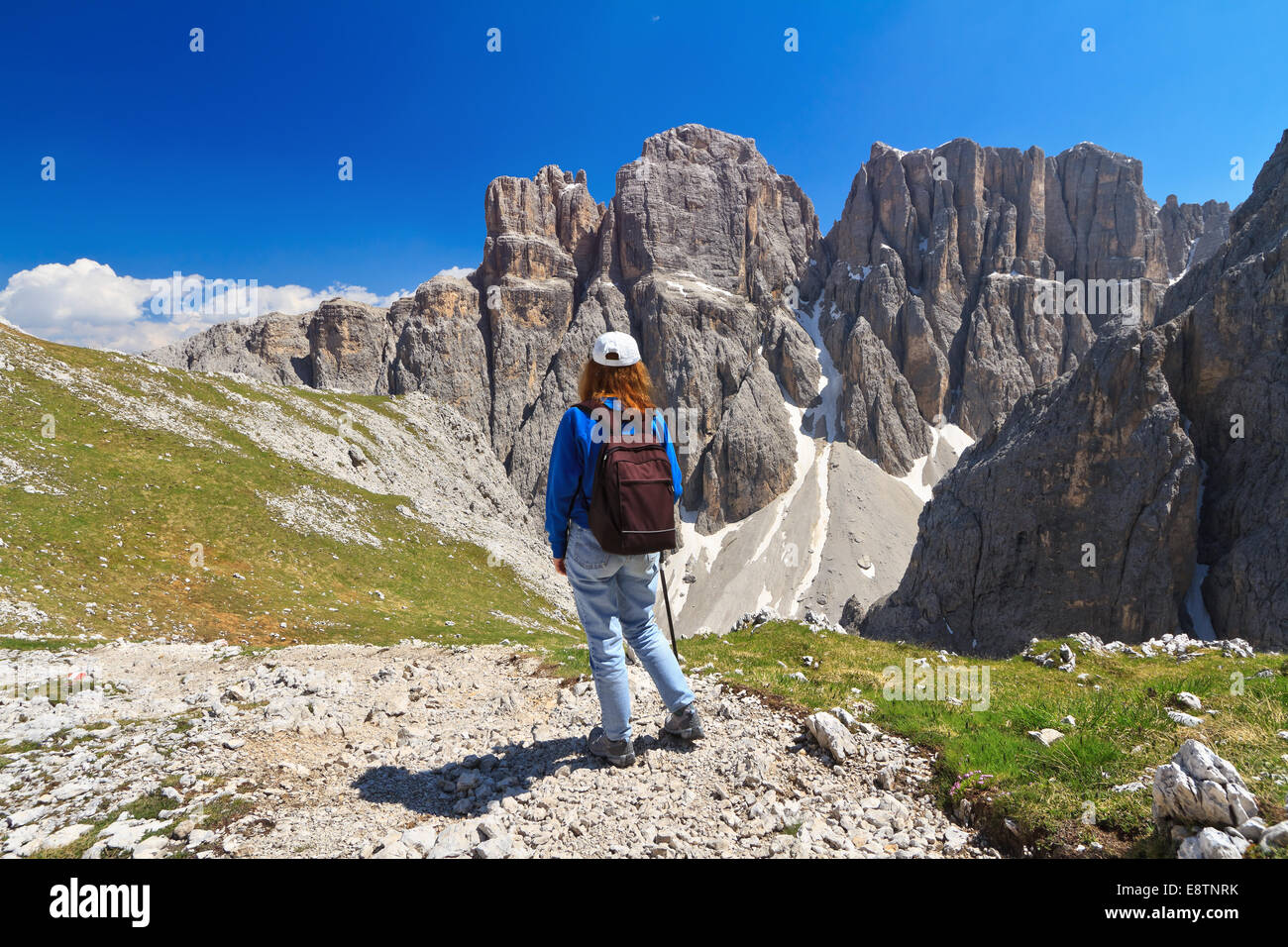 hiker on footpath  in Sella mountain, on background Mezdi valley and Piz da Lech peak, south Tyrol, Italy Stock Photo