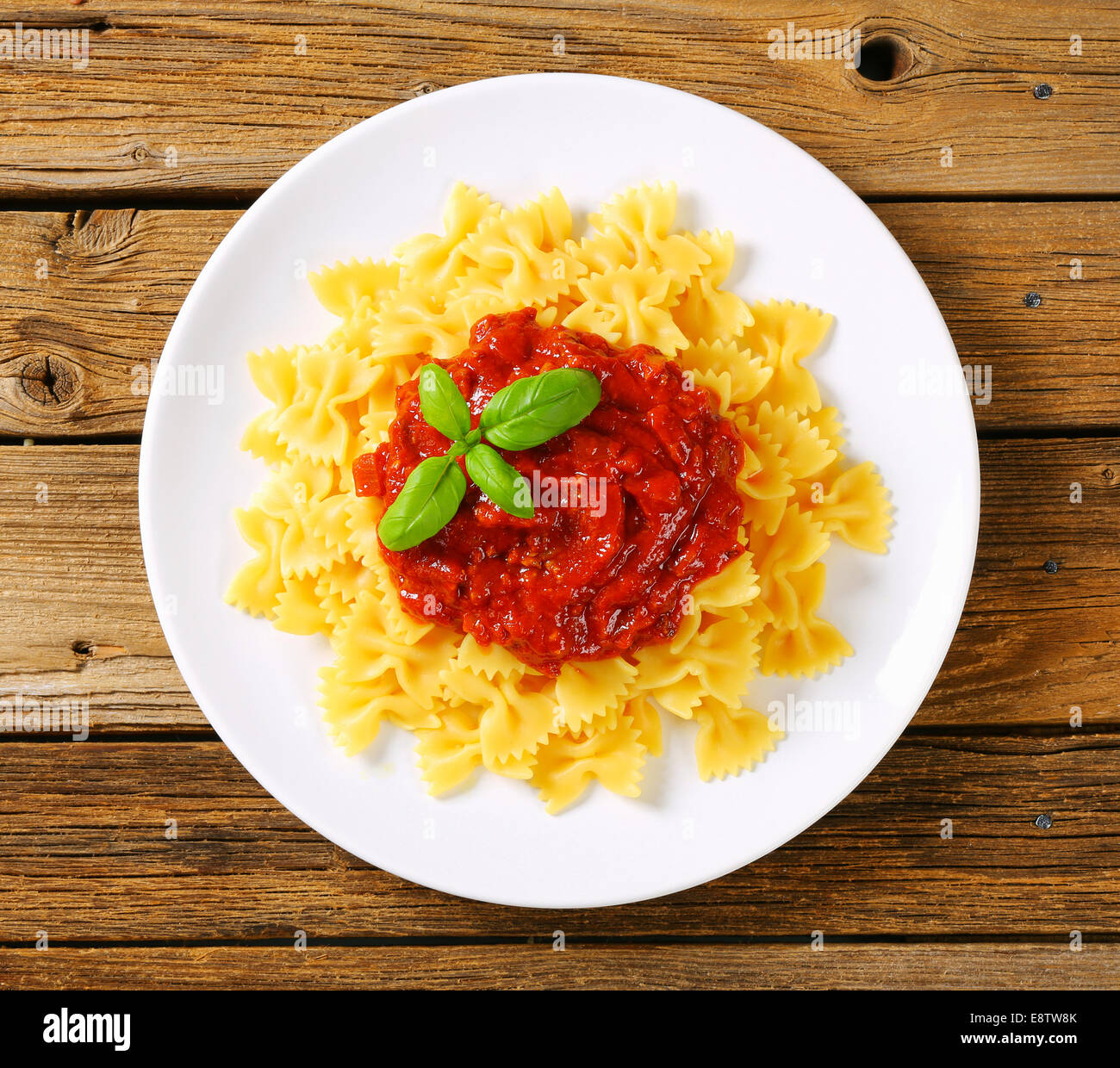 Bowtie pasta with thick tomato sauce Stock Photo Alamy