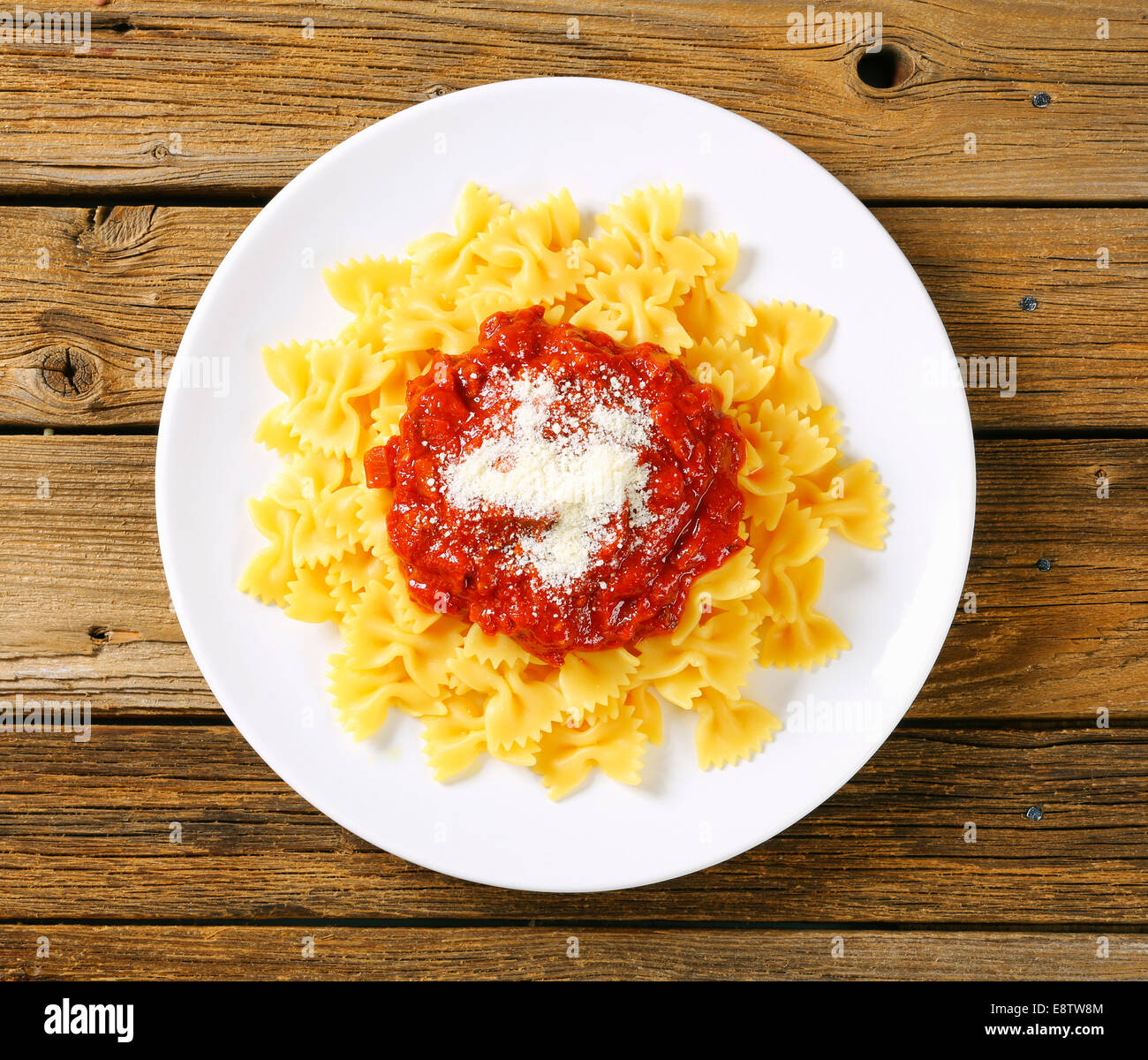 Bowtie pasta with thick tomato sauce and parmesan Stock Photo Alamy