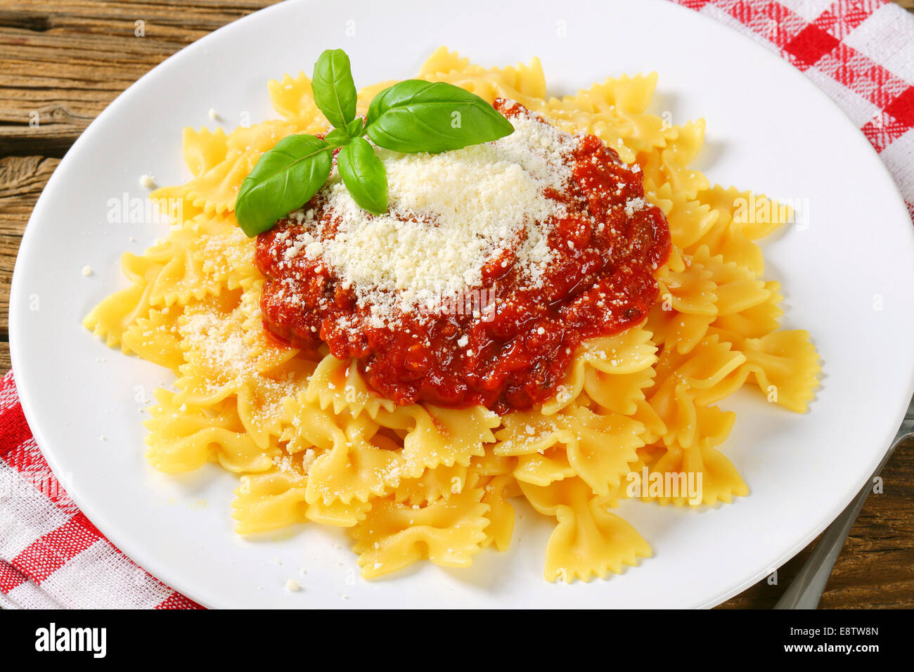Bowtie pasta with thick tomato sauce and parmesan Stock Photo Alamy