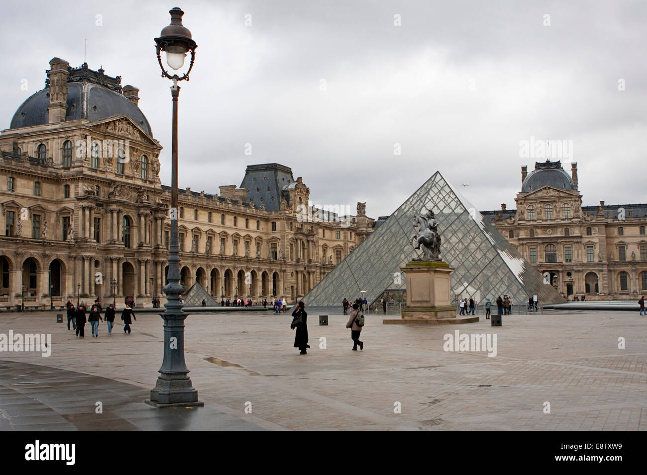 Glass Pyramid and statue outside Le Louvre Stock Photo