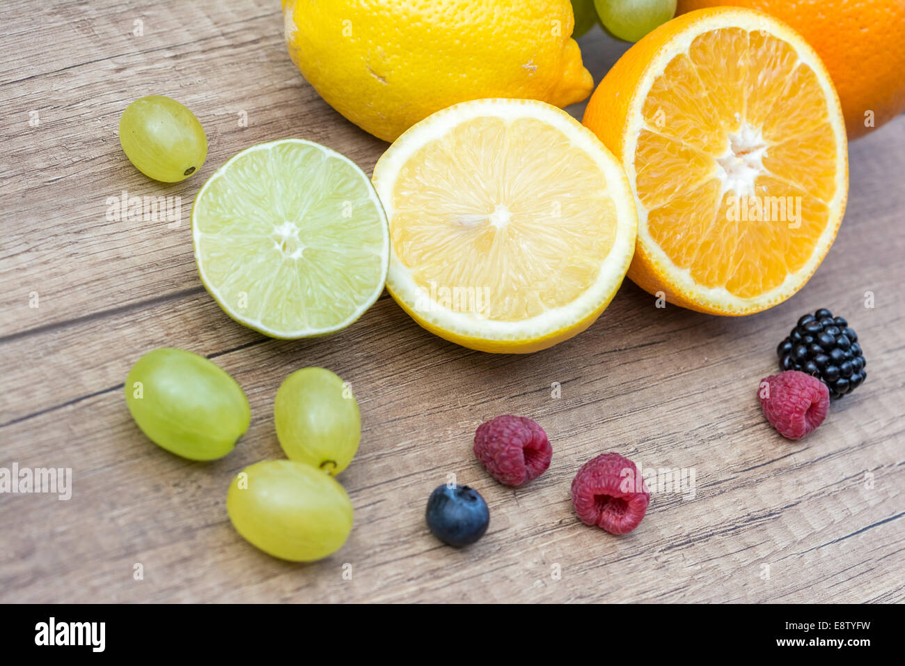Assortment Of Fresh Exotic Fruits On Wood Table Stock Photo - Alamy