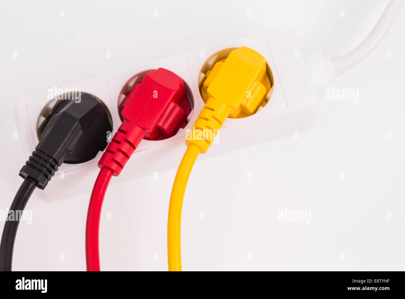 Image shows a multi plug with different colored electrical power cables Stock Photo