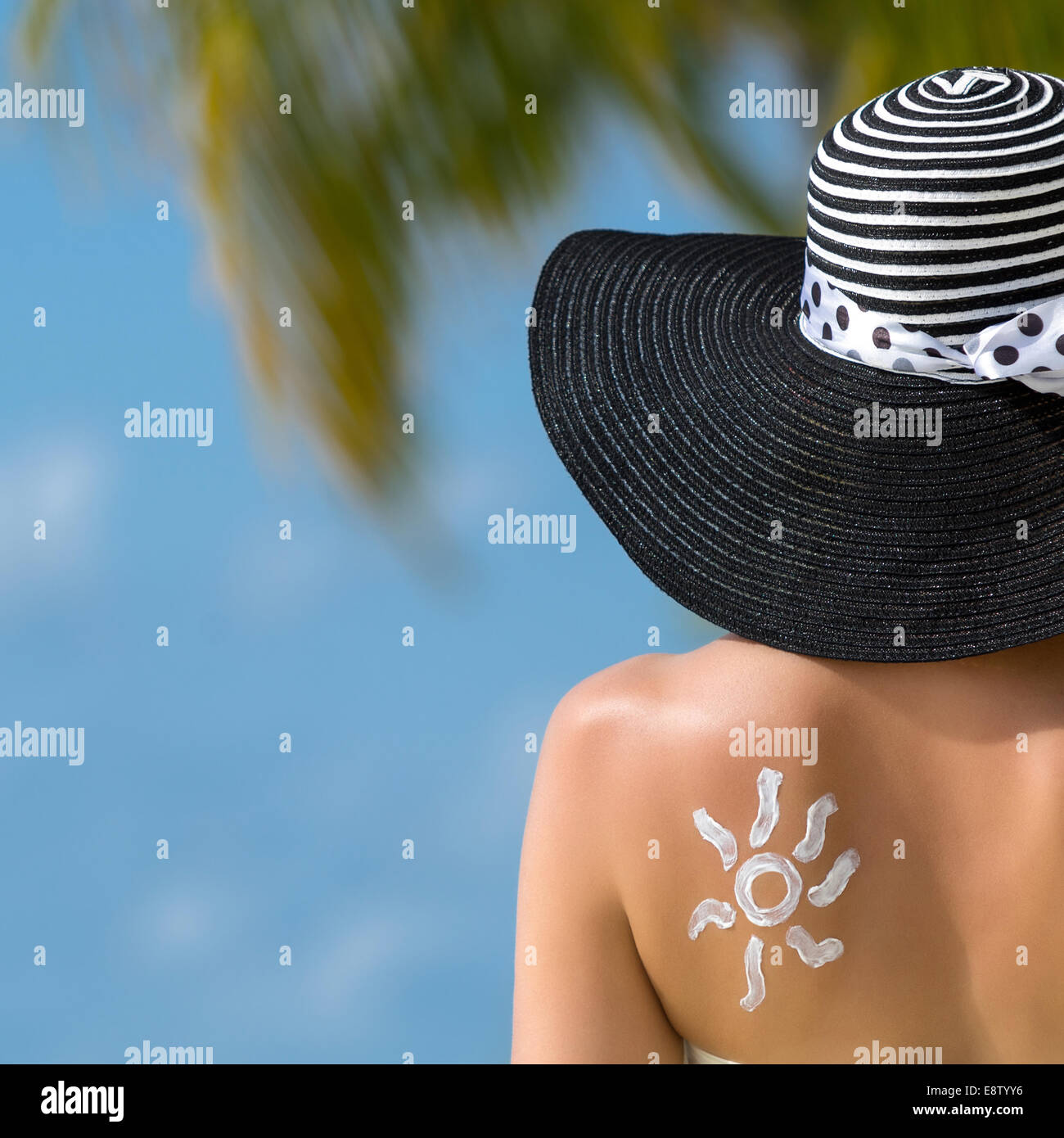 Woman with sun-shaped sun cream Stock Photo
