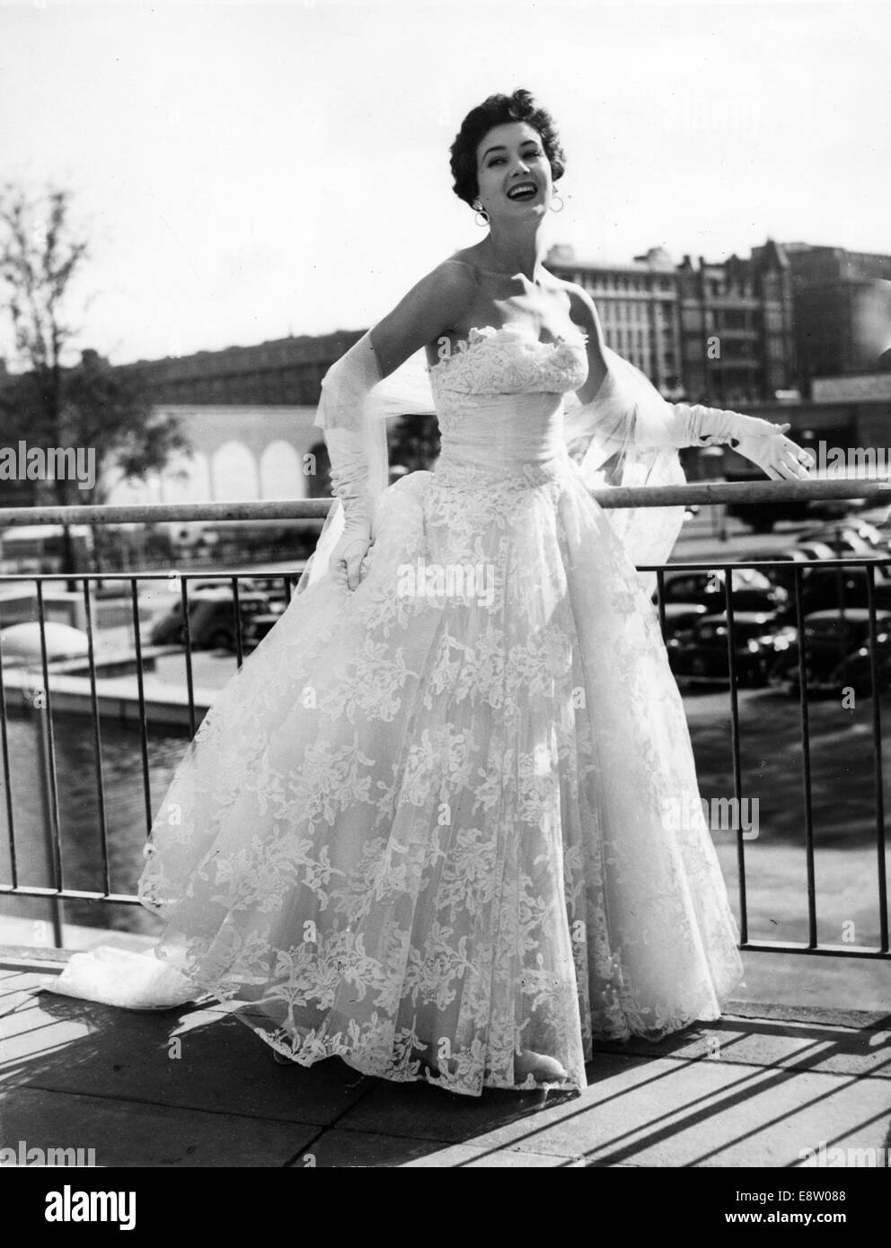 London, UK, UK. 4th Oct, 1954. Model JUNE CLARKE wears a white evening dress  in 'Witchcraft Lace' nylon and net at the National Fabric Fair preview held  at the Royal Festival Hall.