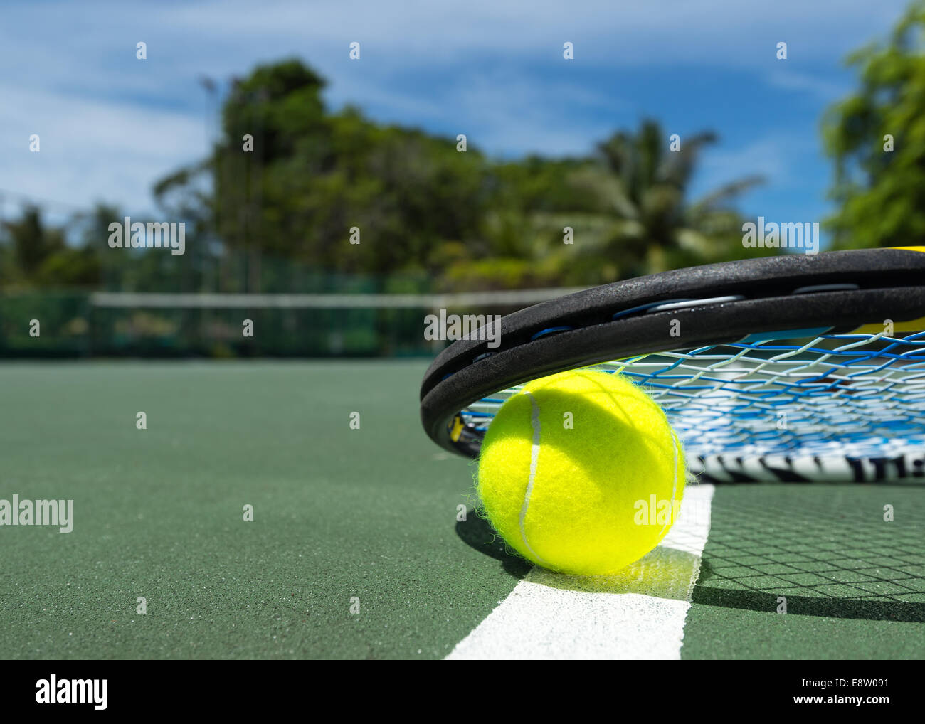 Close up view of tennis racket and balls on the clay tennis court Stock