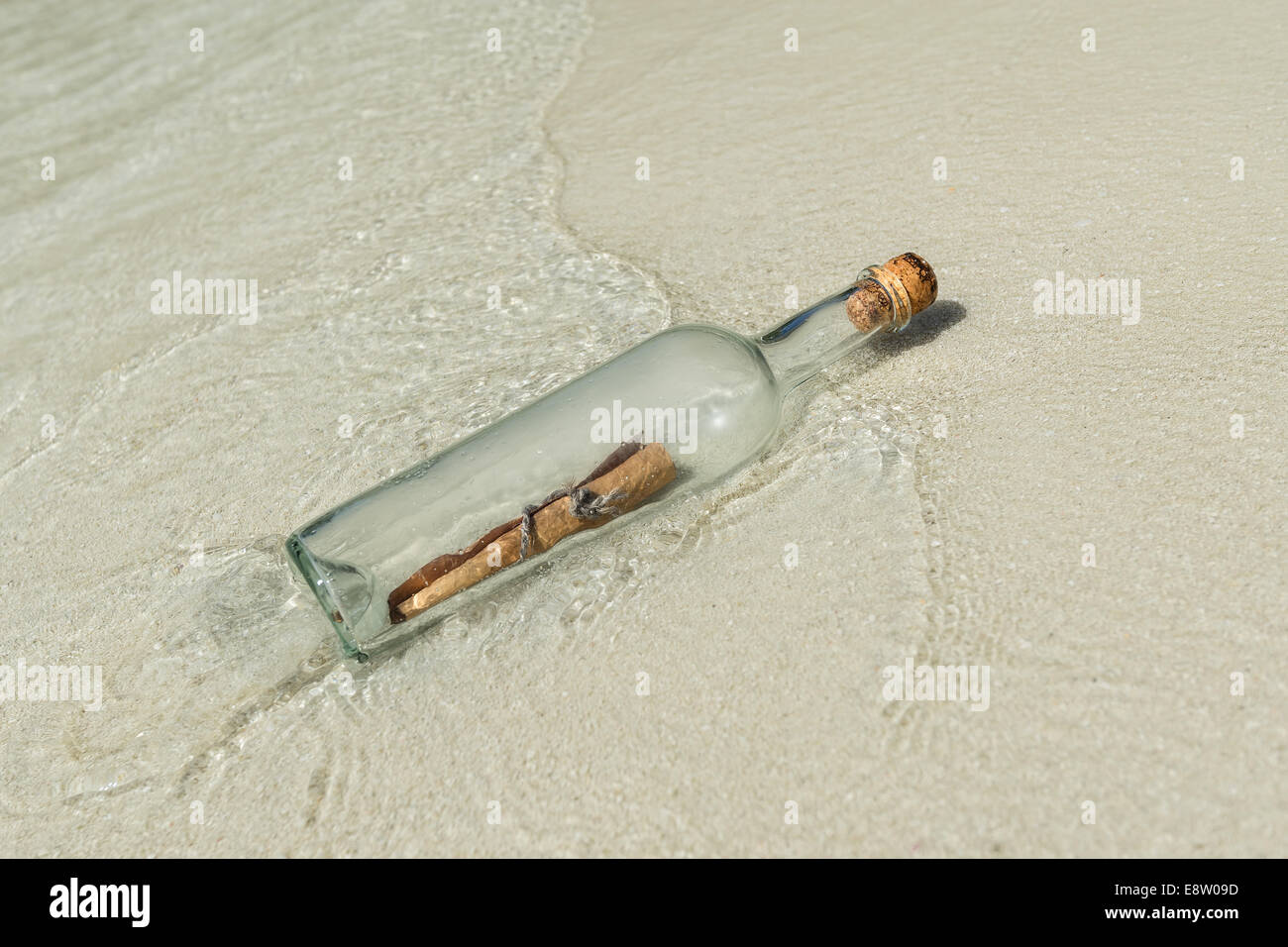 Message in a bottle washed ashore on a tropical beach Stock Photo - Alamy