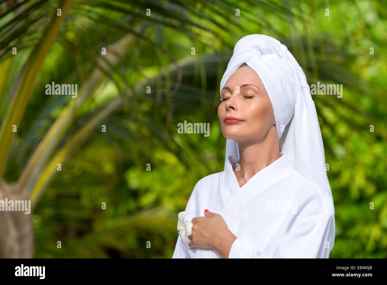 health, spa and beauty concept - beautiful woman in towel Stock Photo