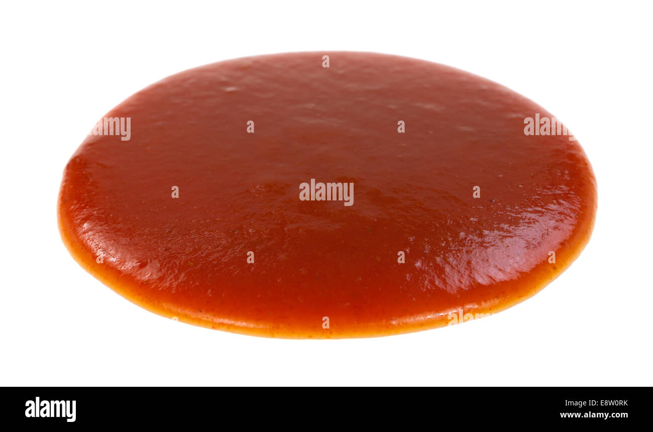 A round blob of red taco sauce on a white background. Stock Photo