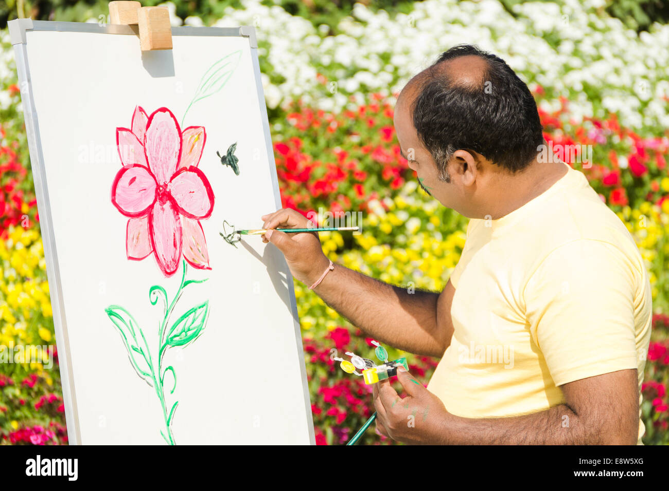 1 Indian man Painting at Canvas Stock Photo