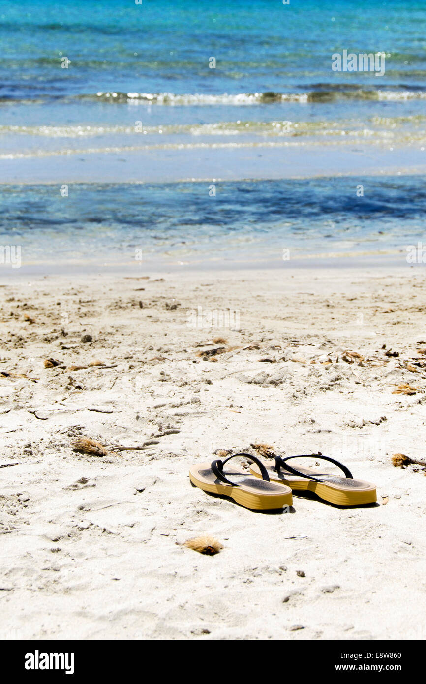 Flip flops on a sandy ocean beach Stock Photo - Alamy