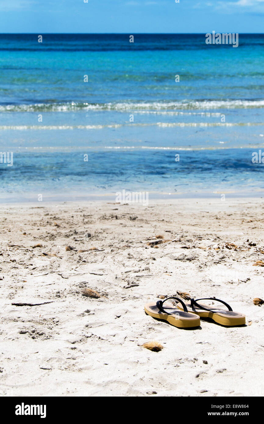 Flip flops on a sandy ocean beach Stock Photo - Alamy